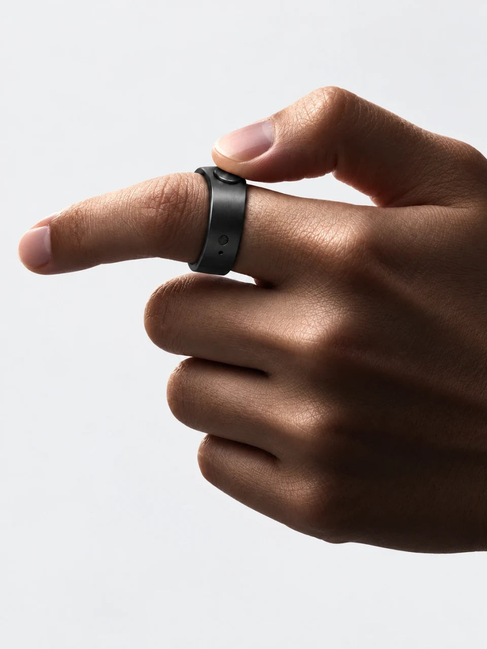 A thumb presses the button on the black Secondly ring.